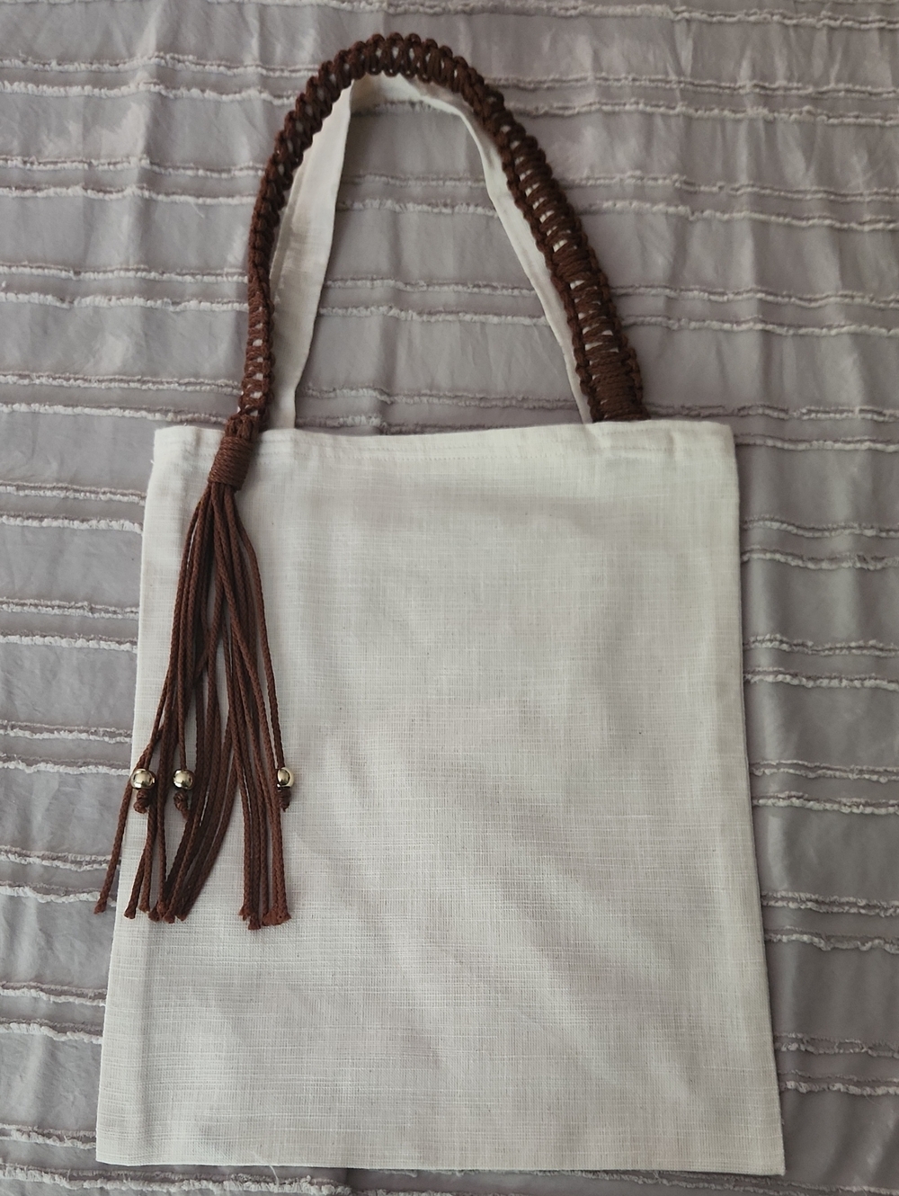 White Canvas Tote with Braided Tassel Handles - Brown, Rust, and Pale Blue.